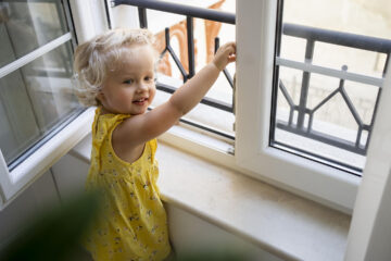 Child by an open window